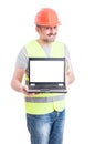 Attractive male constructor showing laptop with empty screen