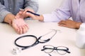 Attractive Male doctor Examining discussing reports with Massage patient suffering from back pain in clinic Royalty Free Stock Photo