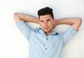 Attractive male fashion model with hands behind head Royalty Free Stock Photo