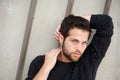 Attractive male fashion model posing with hands behind head Royalty Free Stock Photo