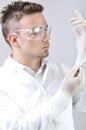 Attractive male medical worker puts on rubber gloves