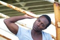 Attractive male model sitting outdoors and looking at camera Royalty Free Stock Photo