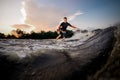 Attractive male wakeboarder riding on the board