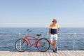 Attractive man with bike near sea