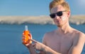 Attractive man with botle of protective sun cream & x28;solar cream, sunscreen& x29;. Young handsome caucasian male model. Royalty Free Stock Photo
