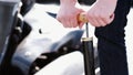 Attractive man checking tire pressure on his gocart