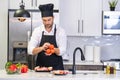 Attractive man cooking in modern kitchen. Handsome man cooking at home preparing salad in kitchen. Casual man preparing Royalty Free Stock Photo