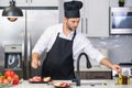 Attractive man cooking in modern kitchen. Handsome man cooking at home preparing salad in kitchen. Casual man preparing Royalty Free Stock Photo