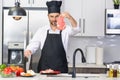 Attractive man cooking in modern kitchen. Handsome man cooking at home preparing salad in kitchen. Casual man preparing Royalty Free Stock Photo