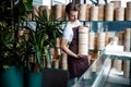 Caucasian concentrated bartender is carrying wooden dishes in the cafe