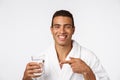 An attractive man drinking a glass of water against white background Royalty Free Stock Photo