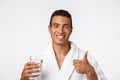 An attractive man drinking a glass of water against white background Royalty Free Stock Photo