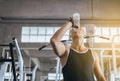 Attractive man drinking water in gym,Men break and relex after workout