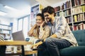 Man in eyeglasses and charming woman using laptop resting at cafe with cup of coffee Royalty Free Stock Photo