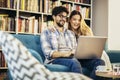 Man in eyeglasses and charming woman using laptop resting at cafe with cup of coffee Royalty Free Stock Photo