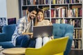 Man in eyeglasses and charming woman using laptop resting at cafe with cup of coffee Royalty Free Stock Photo