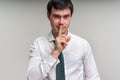 Attractive man with finger on lips making silence gesture Royalty Free Stock Photo