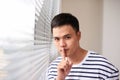 Attractive man with finger on lips making silence gesture. Shh!!! Royalty Free Stock Photo