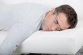 Attractive man with glasses napping on couch Royalty Free Stock Photo