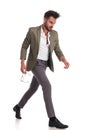 Attractive man with green suit walking to side