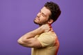 Attractive man has pain in neck.how do you relieve spasms in neck