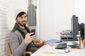 Attractive man in hipster beanie and trendy style businessman working happy at home office with desktop computer Royalty Free Stock Photo