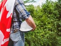 Handsome man with tools, holding a Canadian Flag Royalty Free Stock Photo