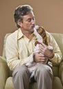 Attractive man kissing dog. Royalty Free Stock Photo