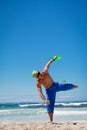 Attractive man playing frisby on beach in summer Royalty Free Stock Photo