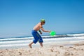 Attractive man playing frisby on beach in summer Royalty Free Stock Photo