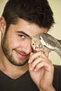 Attractive man playing with his parrot Royalty Free Stock Photo