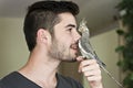 Attractive man playing with his parrot Royalty Free Stock Photo