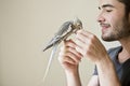 Attractive man playing with his parrot Royalty Free Stock Photo