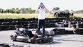 Attractive man putting on a helmet before getting into his gocart