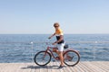 Attractive man riding bike near sea