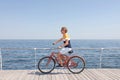 Attractive man riding bike near sea