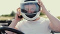 Attractive man sititng in a gocart on the track