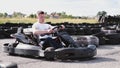 Attractive man sititng in a gocart on the track