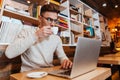 Attractive man sitting in cafe while drinking coffee Royalty Free Stock Photo