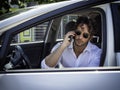 Man sitting in car talking on cell phone Royalty Free Stock Photo