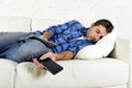 Attractive man sleeping at home couch with mobile phone and digital tablet pad in his hands Royalty Free Stock Photo