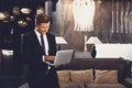 Attractive man standing in the hall and holding his laptop Royalty Free Stock Photo