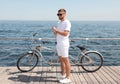 Attractive man with tandem bike near sea