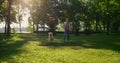 Attractive man throwing round pink toy. Energetic golden retriever catching.