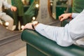 An attractive man is waiting his turn to get a haircut at a busy hair salon. Guy thinking about new haircut Royalty Free Stock Photo