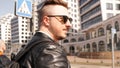 An attractive man wearing black leather jacket with dark sunglasses Royalty Free Stock Photo