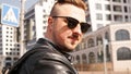 An attractive man wearing black leather jacket with dark sunglasses Royalty Free Stock Photo