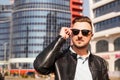 An attractive man wearing black leather jacket with dark sunglasses Royalty Free Stock Photo