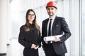 An attractive man and woman business team working construction on the building site near panoramic windows Royalty Free Stock Photo