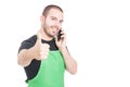 Attractive market seller making like gesture at phone